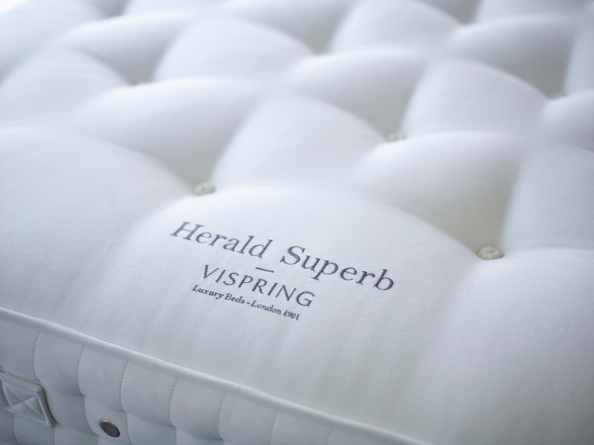 Close detail of the evenly dimpled surface of a hand-tufted Vispring mattress