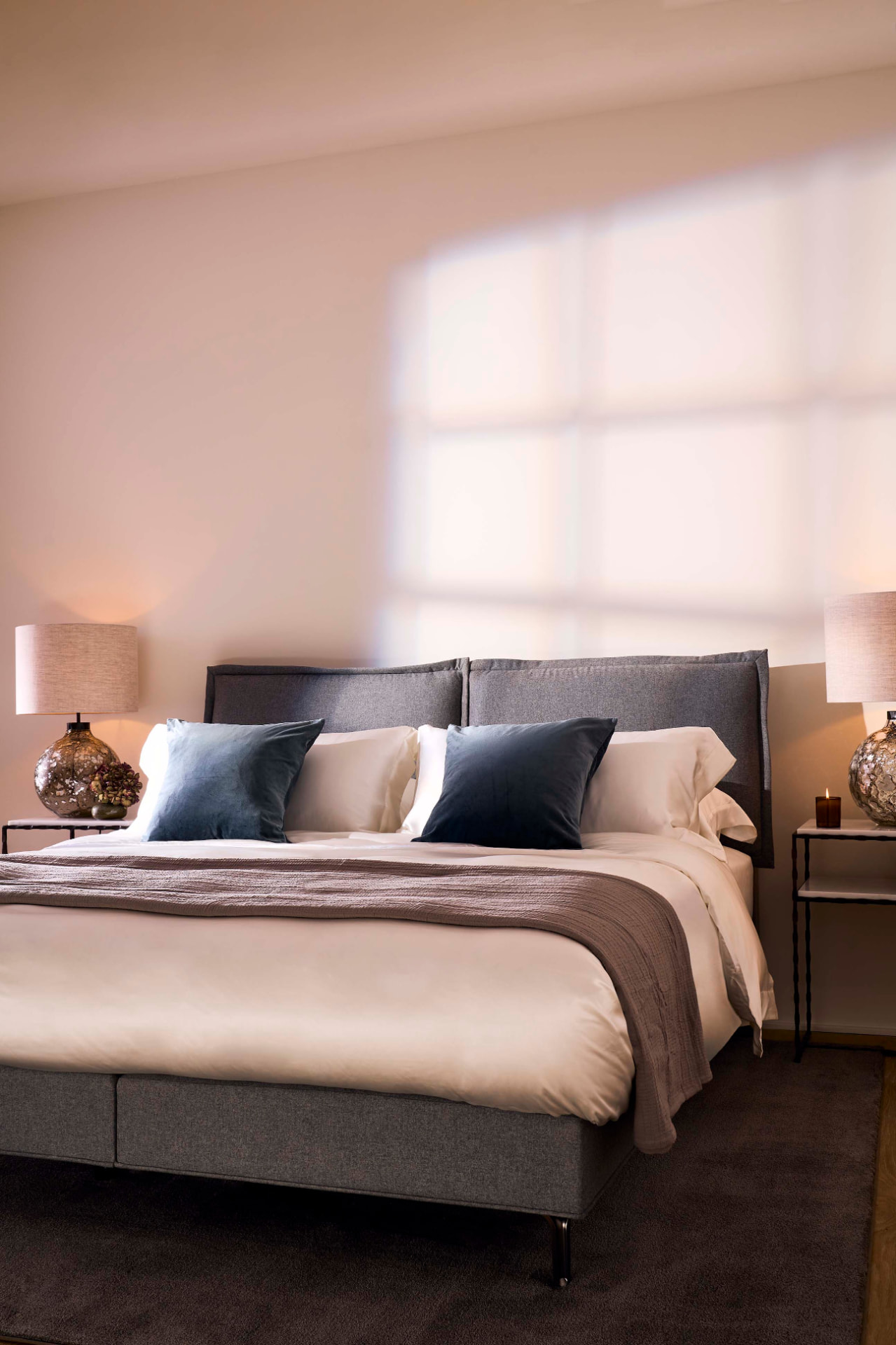 The Katherine bed set dressed in tailored wool flannel, photographed at an angle