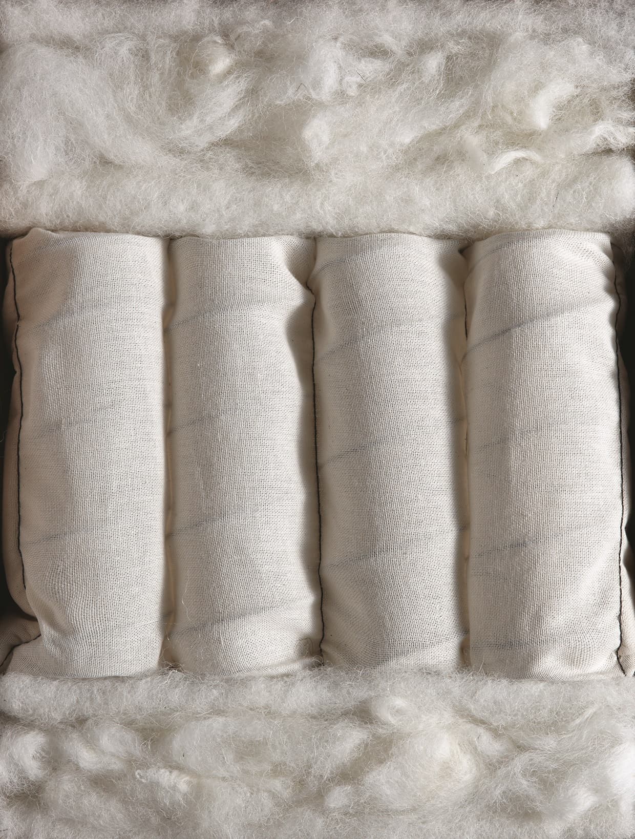 Cut-through of the Devonshire mattress, with wool comfort layers above and below its pocket springs