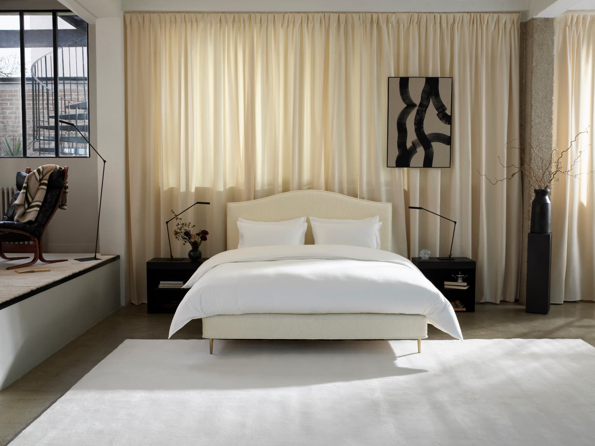 A Vispring Original Collection bed dressed in ivory linen in a calm, light-filled bedroom