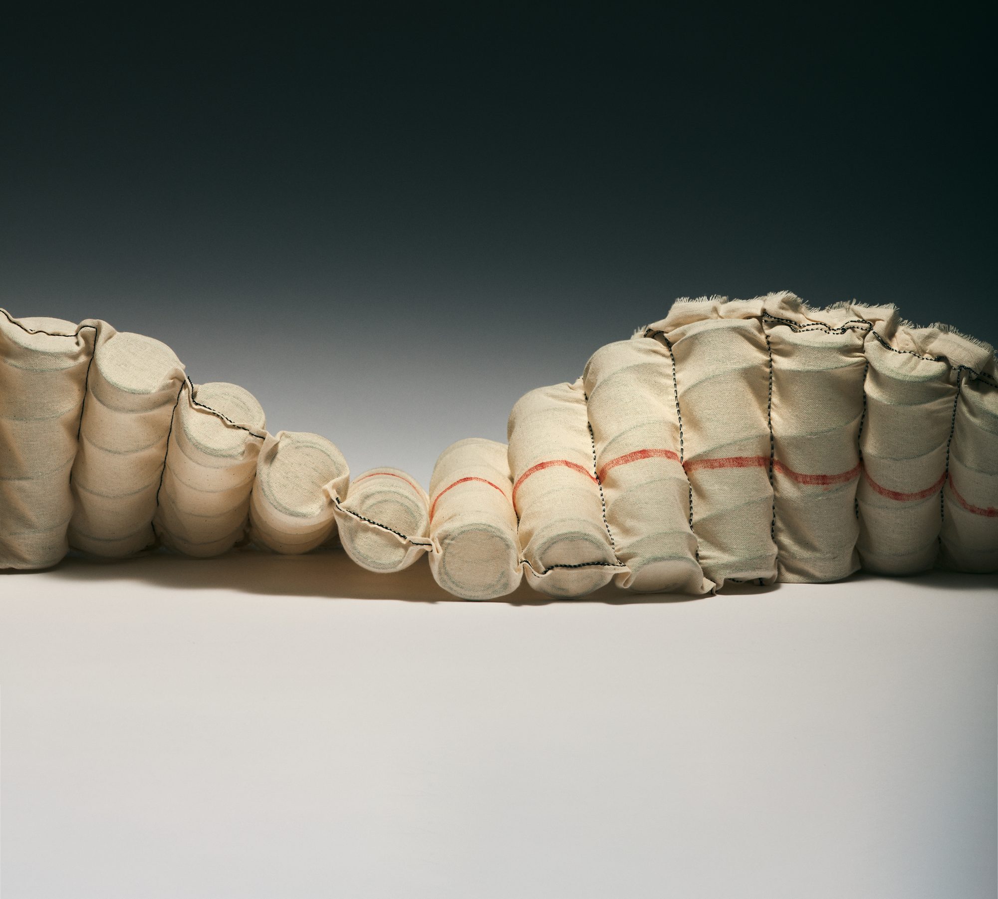 Hand-nested calico pocket springs arranged in two layers